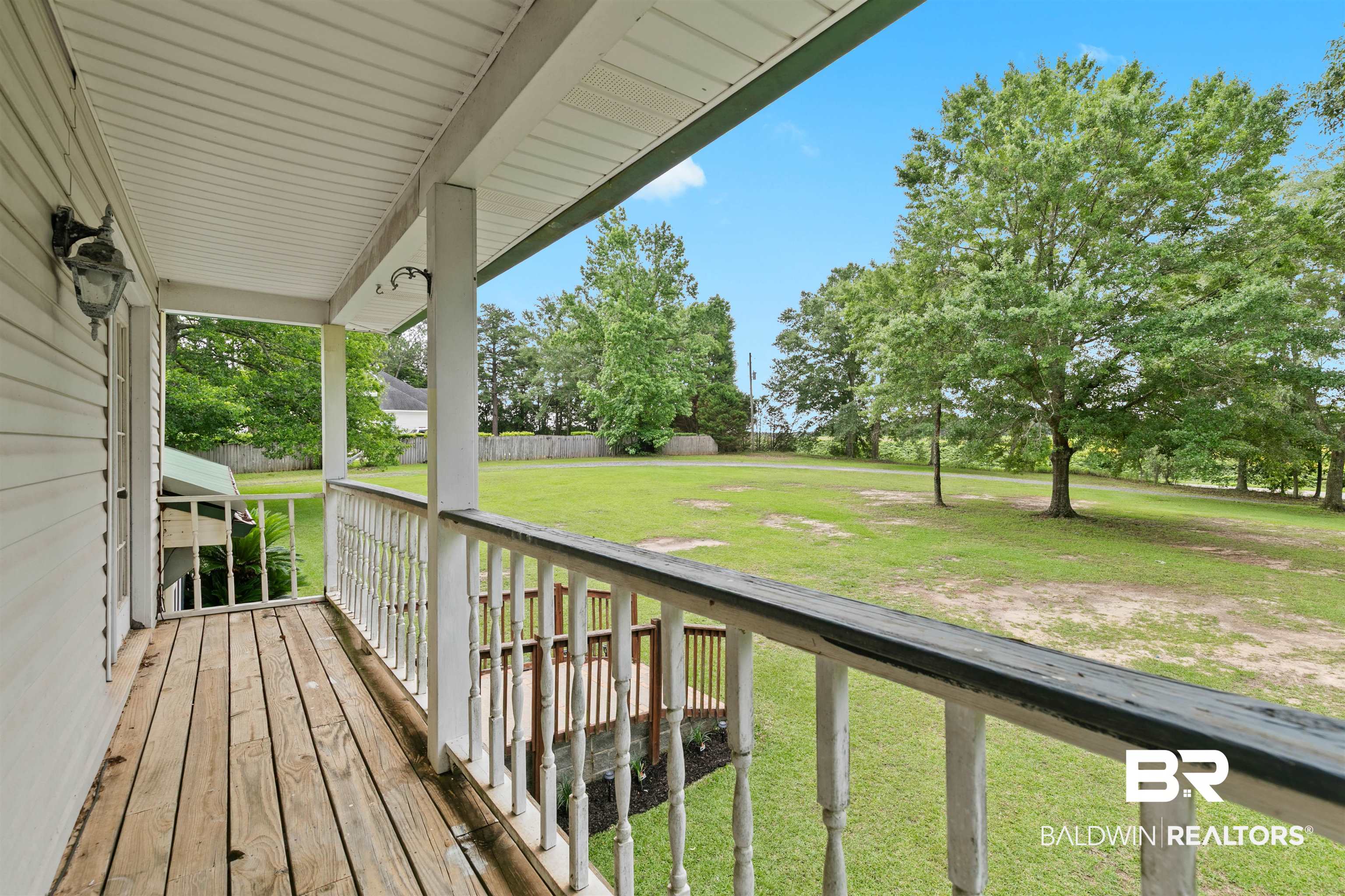 10420 Johnson Road South Mobile, AL 36695 - Photo 45 of 75 Expansive front porch featuring wood plank flooring and white spindle railings