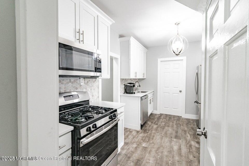 306 Henley Avenue, Unit A Pine Beach, NJ 08741 - Photo 1 of 16 a kitchen with a stove and a refrigerator