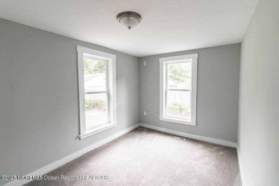 306 Henley Avenue, Unit A Pine Beach, NJ 08741 - Photo 12 of 16 a view of an empty room with a window