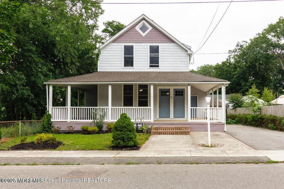 306 Henley Avenue, Unit A Pine Beach, NJ 08741 - Photo 16 of 16 a front view of a house with a yard and potted plants