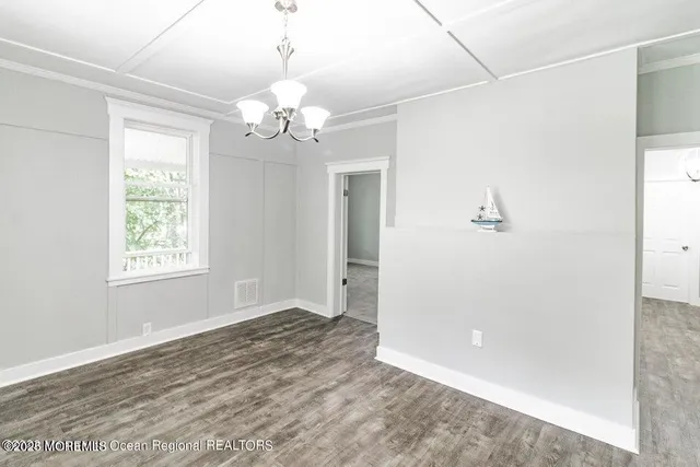 a view of a chandelier in a room with a window