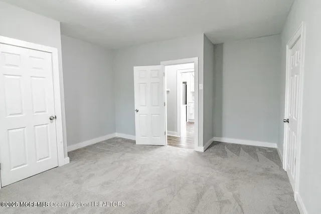 an empty room with closet area