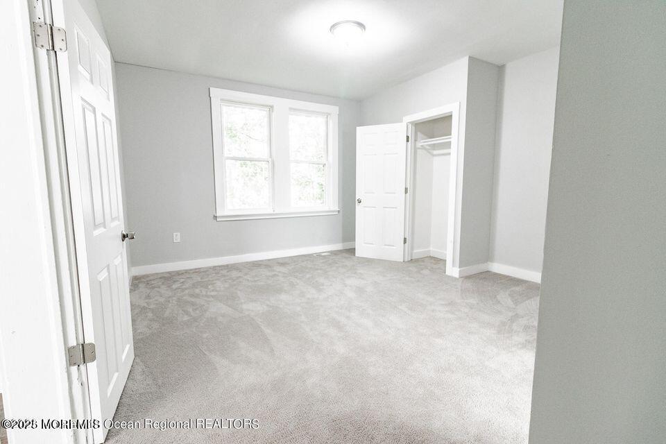 306 Henley Avenue, Unit A Pine Beach, NJ 08741 - Photo 7 of 16 a view of an empty room with a window
