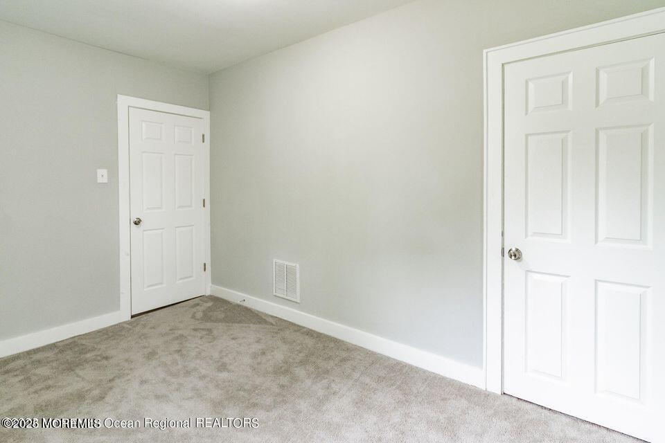 306 Henley Avenue, Unit A Pine Beach, NJ 08741 - Photo 10 of 16 an empty room with windows