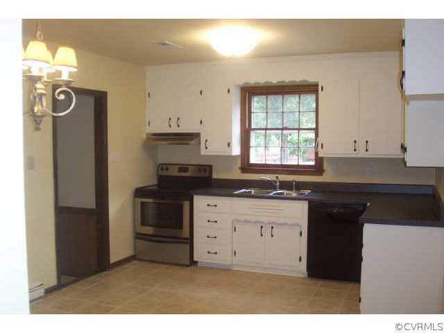 15712 Saddlebrook Road Chesterfield, VA 23838 - Photo 5 of 7 a kitchen with granite countertop white cabinets and black appliances