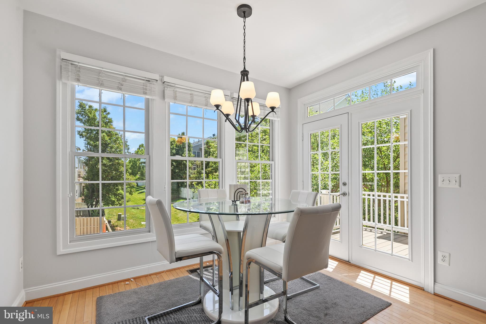 6806 Witton Circle Gainesville, VA 20155 - Photo 7 of 47 a view of a dining room with furniture window and wooden floor