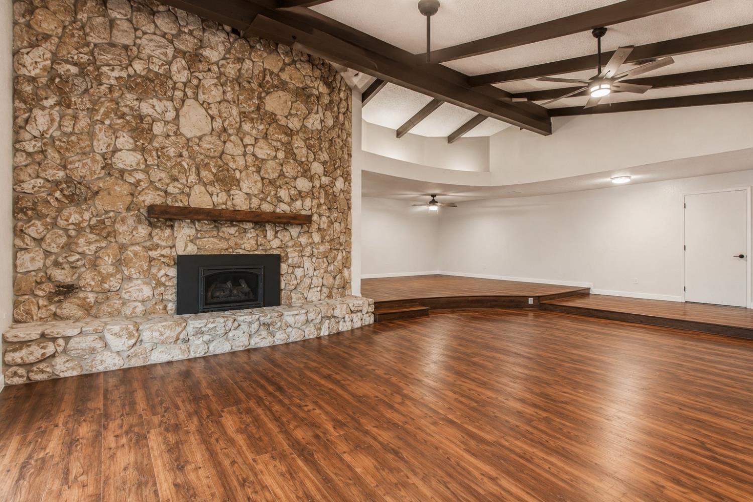 1908 Chelwood Way Modesto, CA 95355 - Photo 11 of 32 a view of empty room with wooden floor and fireplace