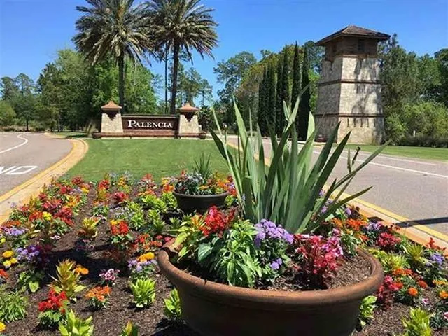 a view of a potted flower in a garden with a fountain