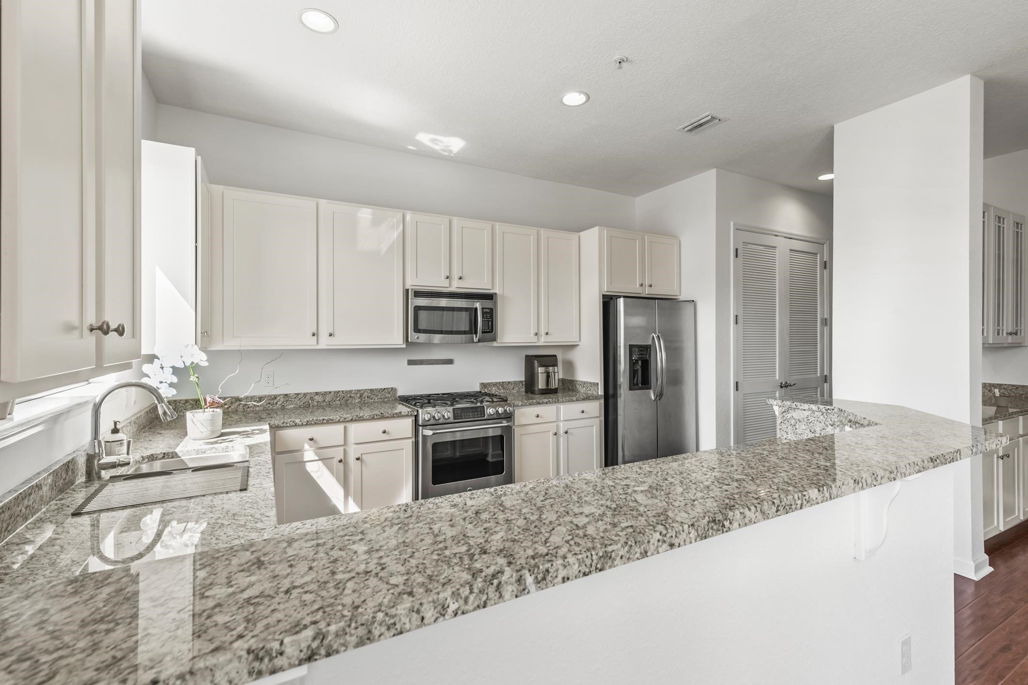 654 Market Street St. Augustine, FL 32095 - Photo 11 of 38 a kitchen with stainless steel appliances granite countertop a sink stove and refrigerator