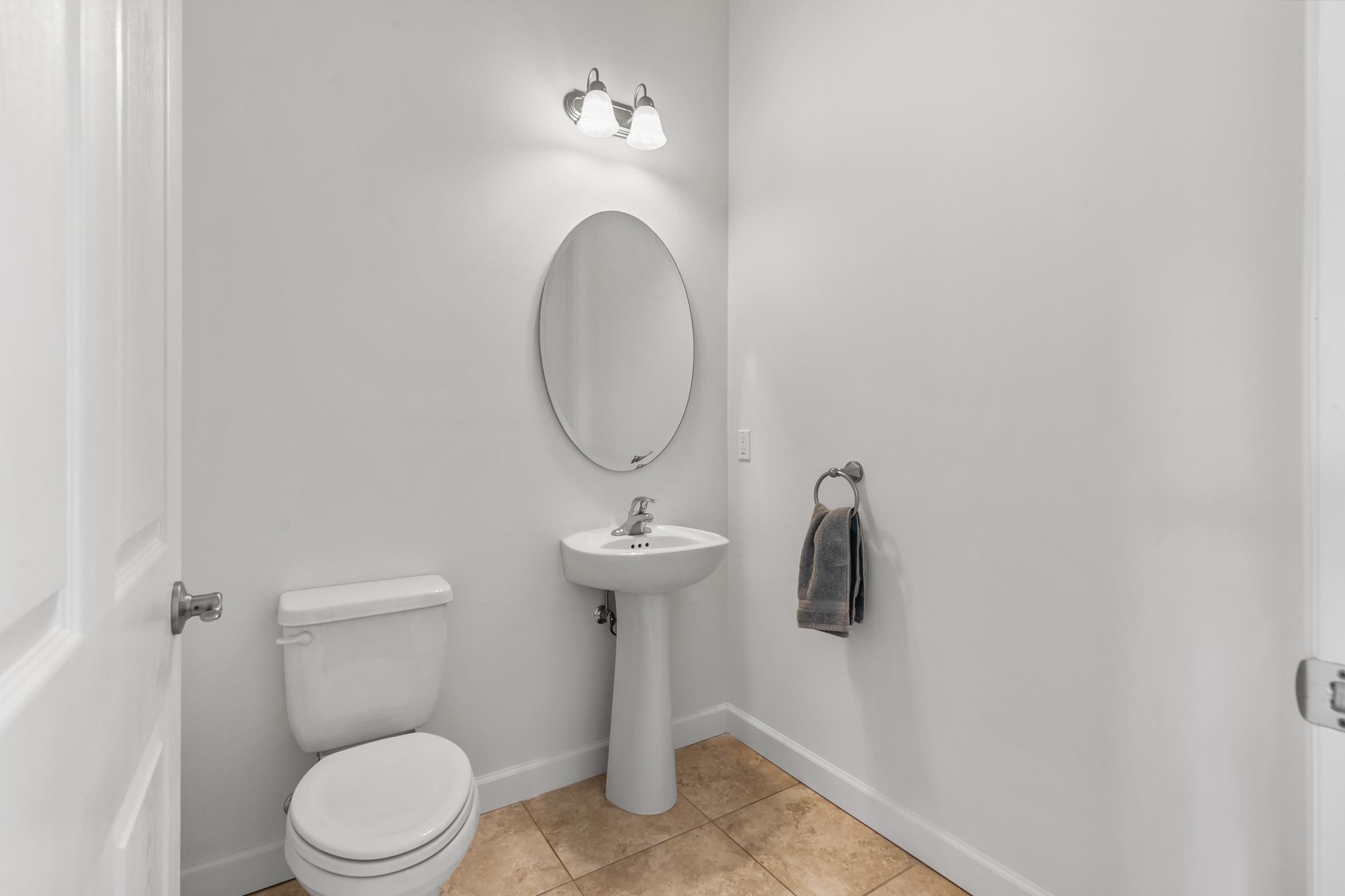 654 Market Street St. Augustine, FL 32095 - Photo 15 of 38 a bathroom with a toilet sink and mirror