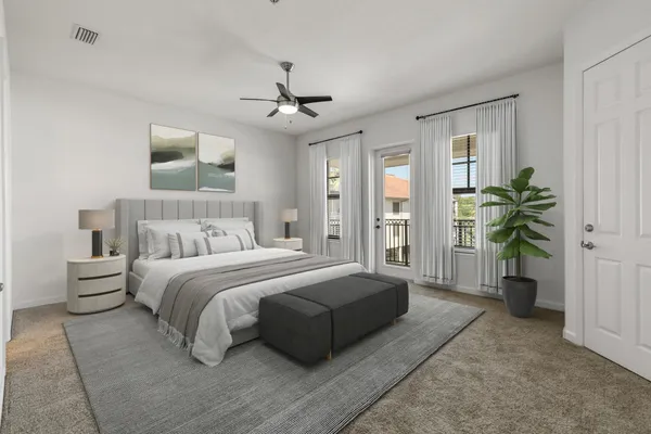 a spacious bedroom with a large bed and a chandelier