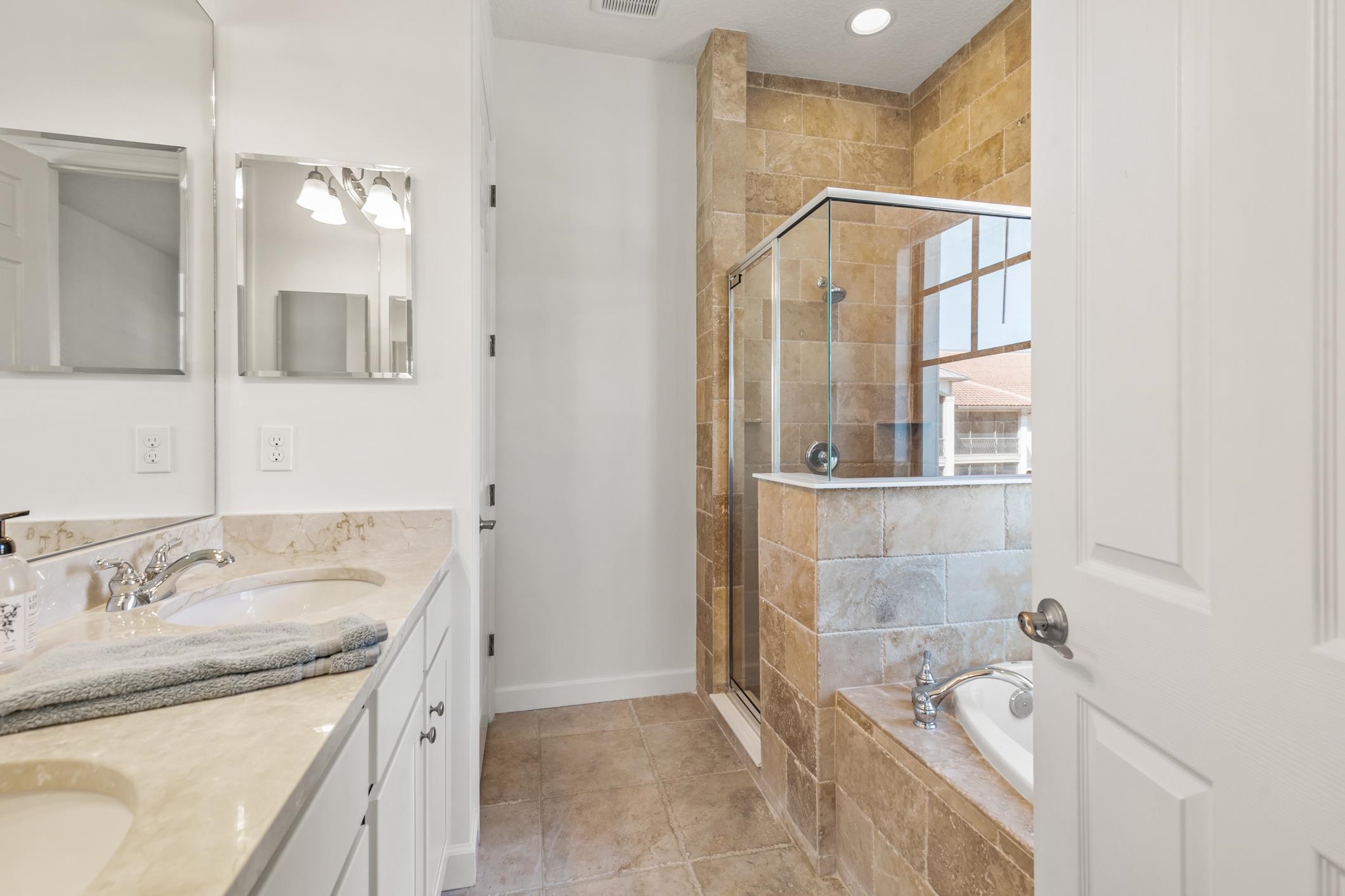 654 Market Street St. Augustine, FL 32095 - Photo 22 of 38 a bathroom with a granite countertop sink mirror and shower