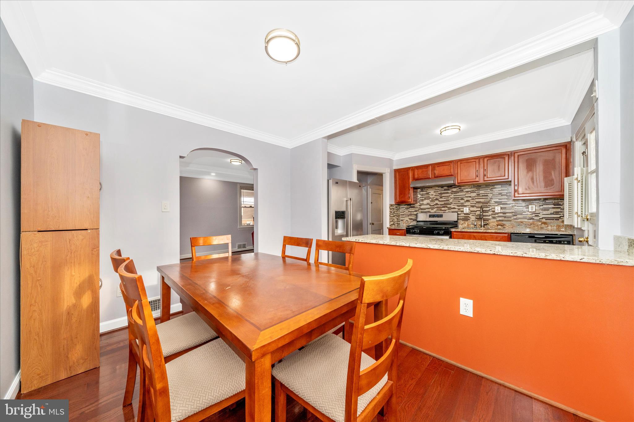 821 Rittenhouse Street Hyattsville, MD 20783 - Photo 11 of 59 a dining room with furniture and a floor to ceiling window