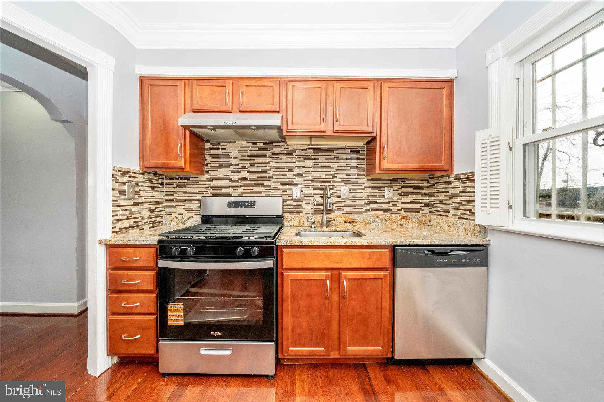 821 Rittenhouse Street Hyattsville, MD 20783 - Photo 14 of 59 a kitchen with wooden cabinets and a stove top oven