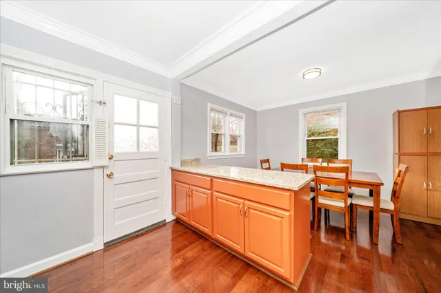 a view of a kitchen with stainless steel appliances granite countertop a sink and a stove