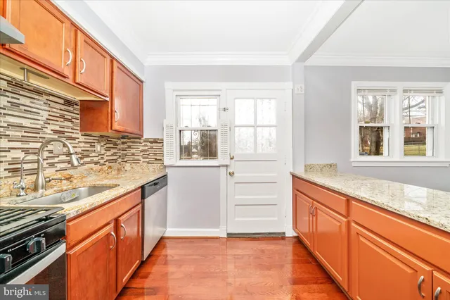 a kitchen with stainless steel appliances granite countertop a stove a refrigerator and a sink