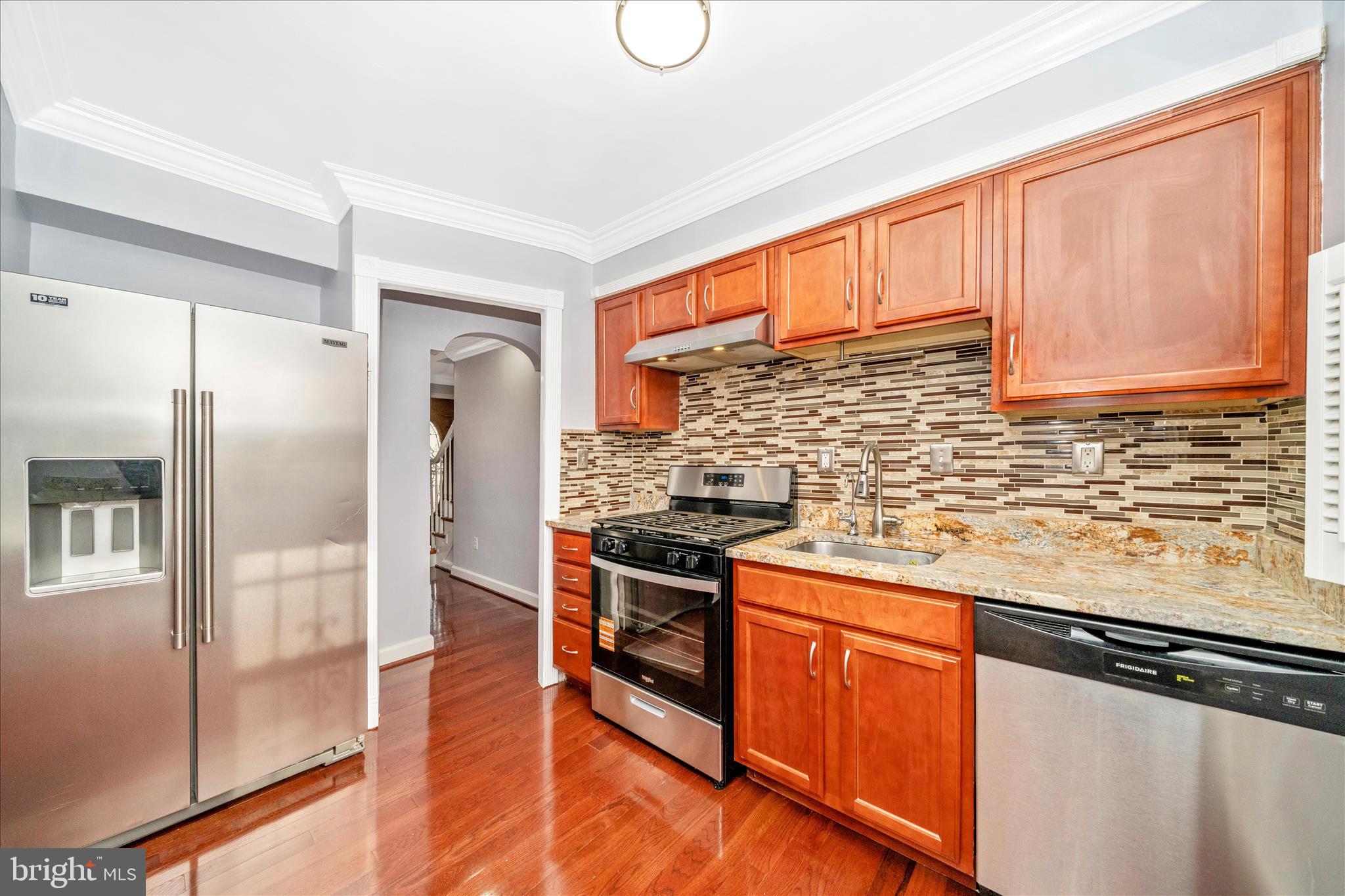 821 Rittenhouse Street Hyattsville, MD 20783 - Photo 18 of 59 a kitchen with stainless steel appliances granite countertop a stove a refrigerator and a sink