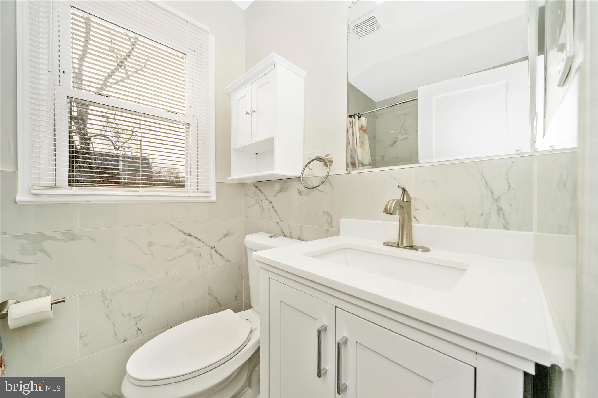821 Rittenhouse Street Hyattsville, MD 20783 - Photo 26 of 59 a bathroom with a sink a toilet and a mirror