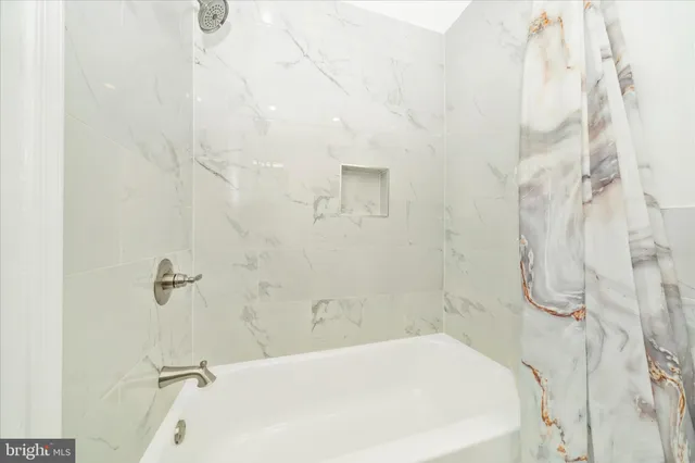 a bedroom with a bed and a mirror