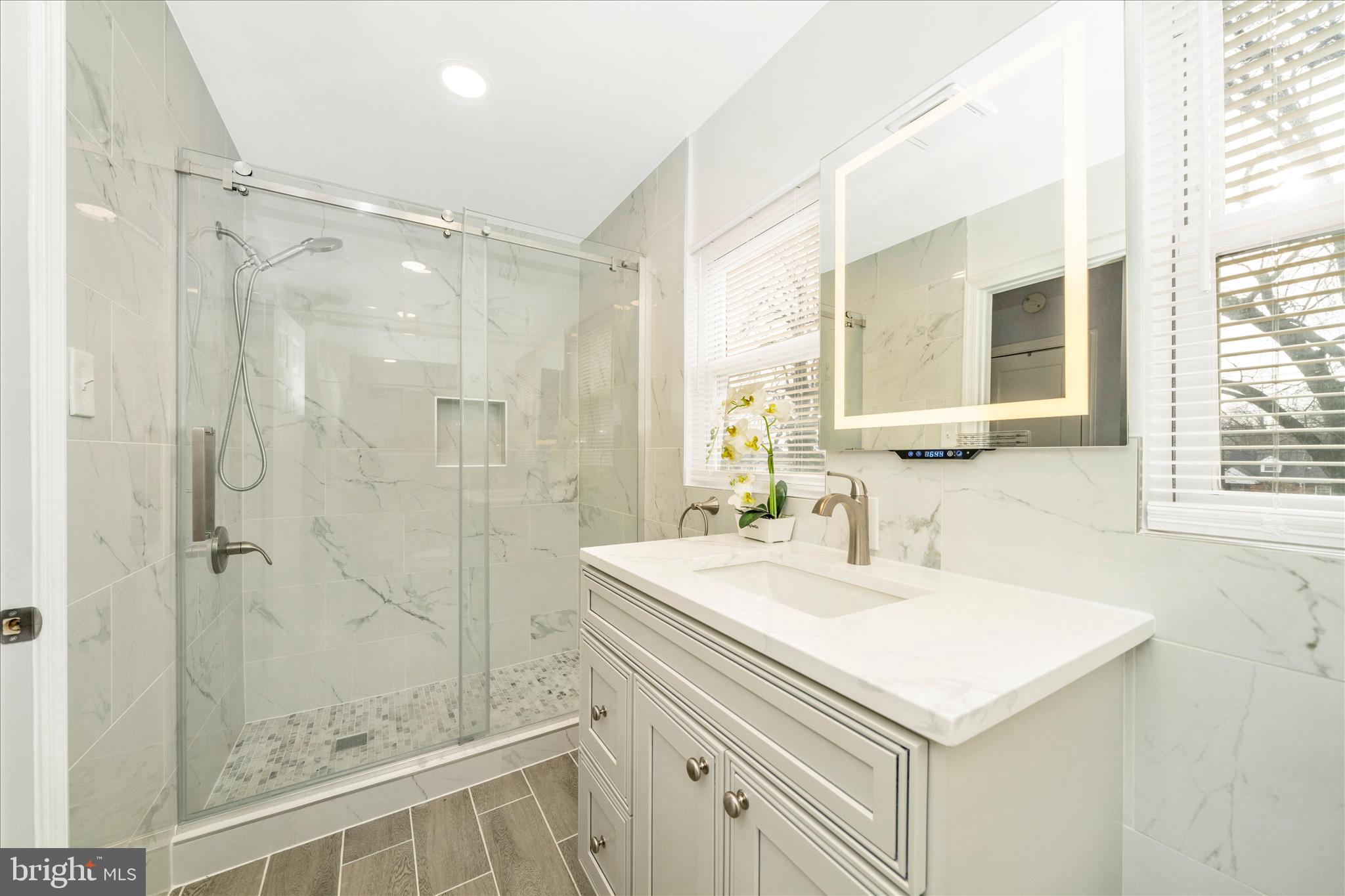 821 Rittenhouse Street Hyattsville, MD 20783 - Photo 31 of 59 a bathroom with a sink a mirror and a shower