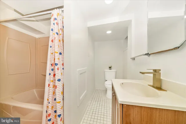 a backyard of a house with wooden fence and large trees