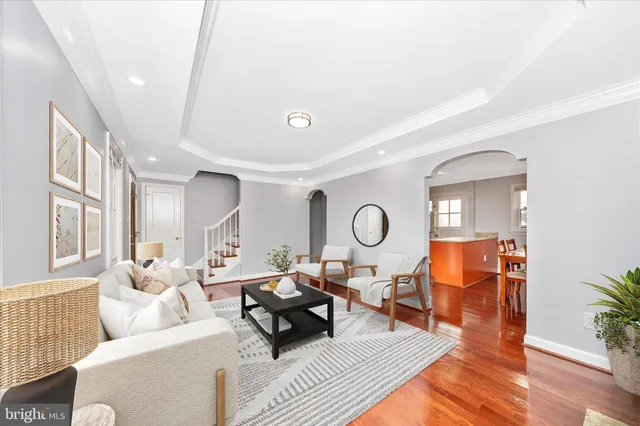 a living room with furniture a fireplace and a large window