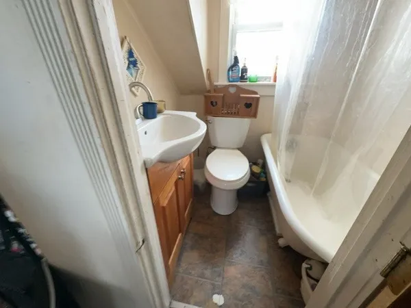 a white toilet sitting next to a sink