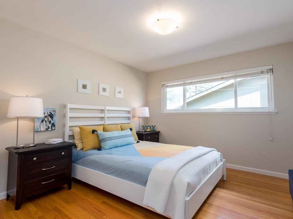 3410 Hillcrest Drive Belmont, CA 94002 - Photo 16 of 26 a bedroom with a bed and a lamp