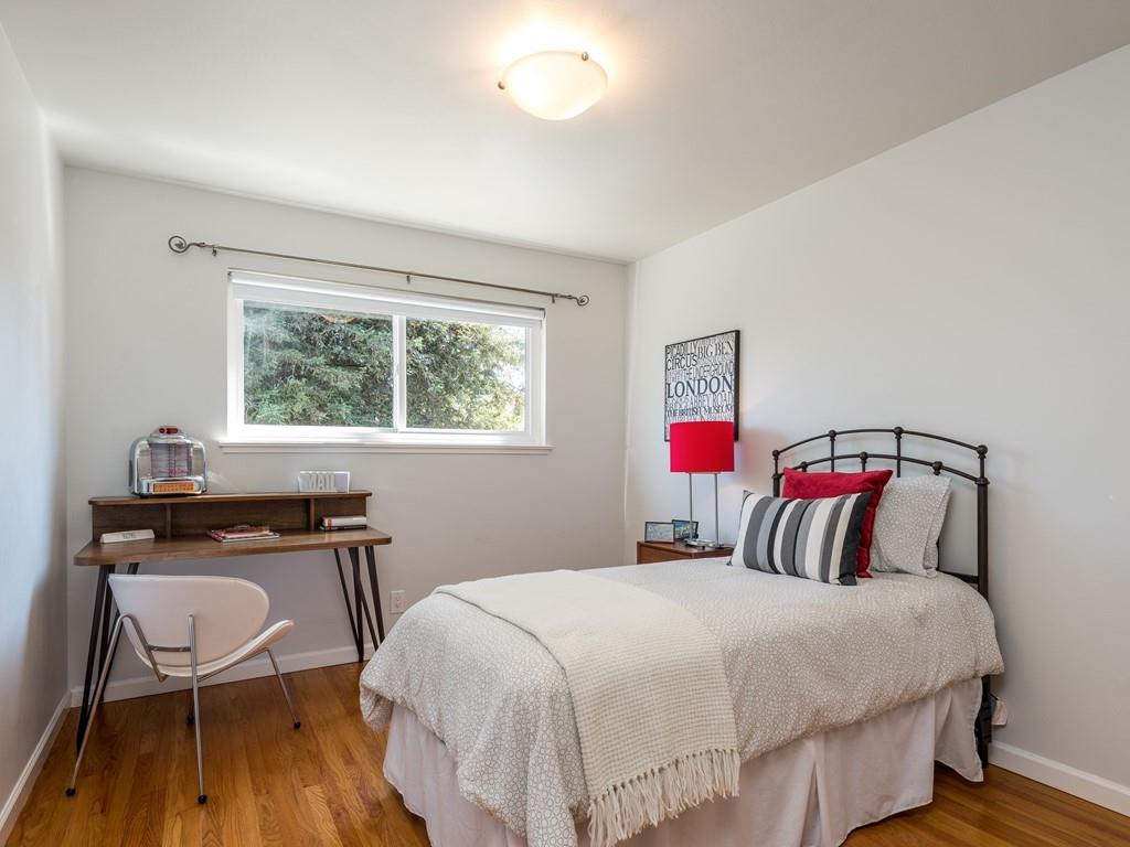 3410 Hillcrest Drive Belmont, CA 94002 - Photo 19 of 26 a bedroom with a bed a table and a window
