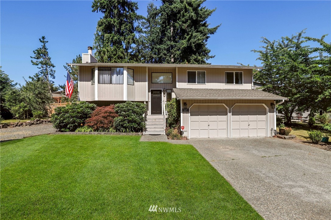 1417 234th Street Southwest Bothell, WA 98021 - Photo 1 of 40 a front view of a house with a yard