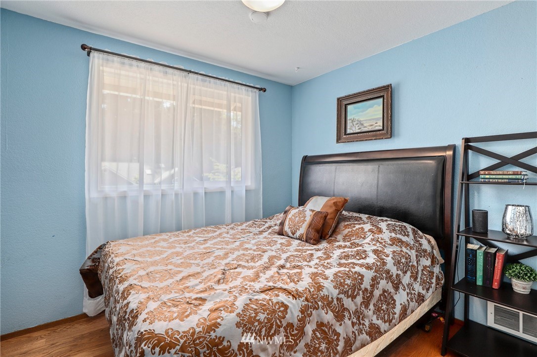 1417 234th Street Southwest Bothell, WA 98021 - Photo 11 of 40 a bedroom with a bed and painting on the wall