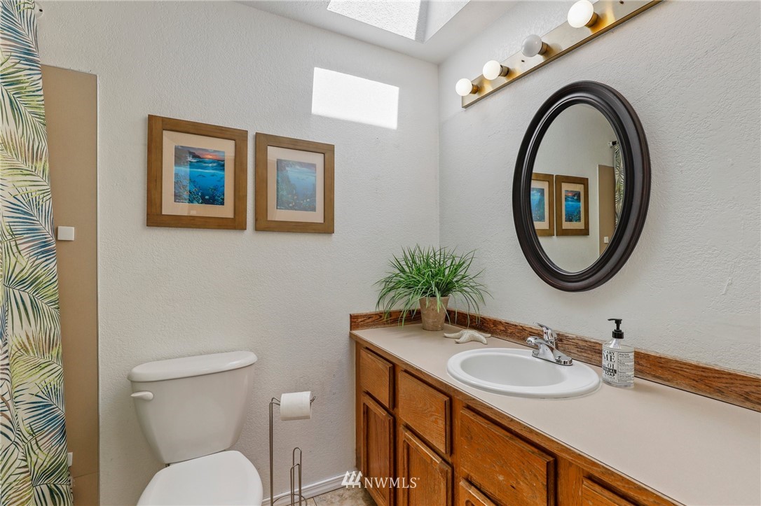 1417 234th Street Southwest Bothell, WA 98021 - Photo 16 of 40 a bathroom with a toilet a sink and a mirror