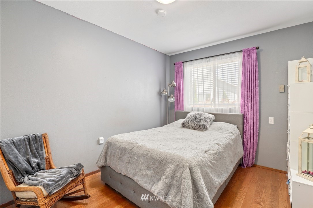 1417 234th Street Southwest Bothell, WA 98021 - Photo 17 of 40 a bedroom with a bed and wooden floor