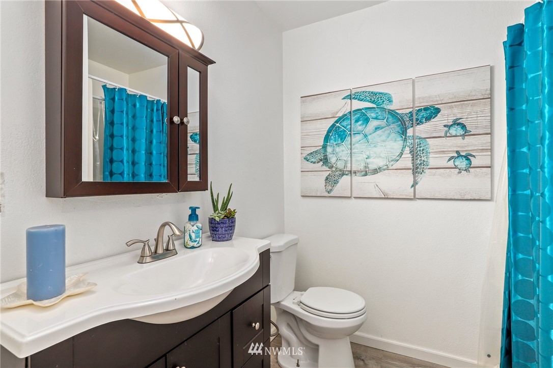 1417 234th Street Southwest Bothell, WA 98021 - Photo 18 of 40 a bathroom with a sink a toilet and mirror