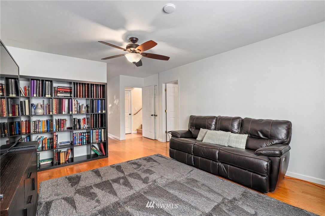 1417 234th Street Southwest Bothell, WA 98021 - Photo 20 of 40 a living room with furniture and a book shelf