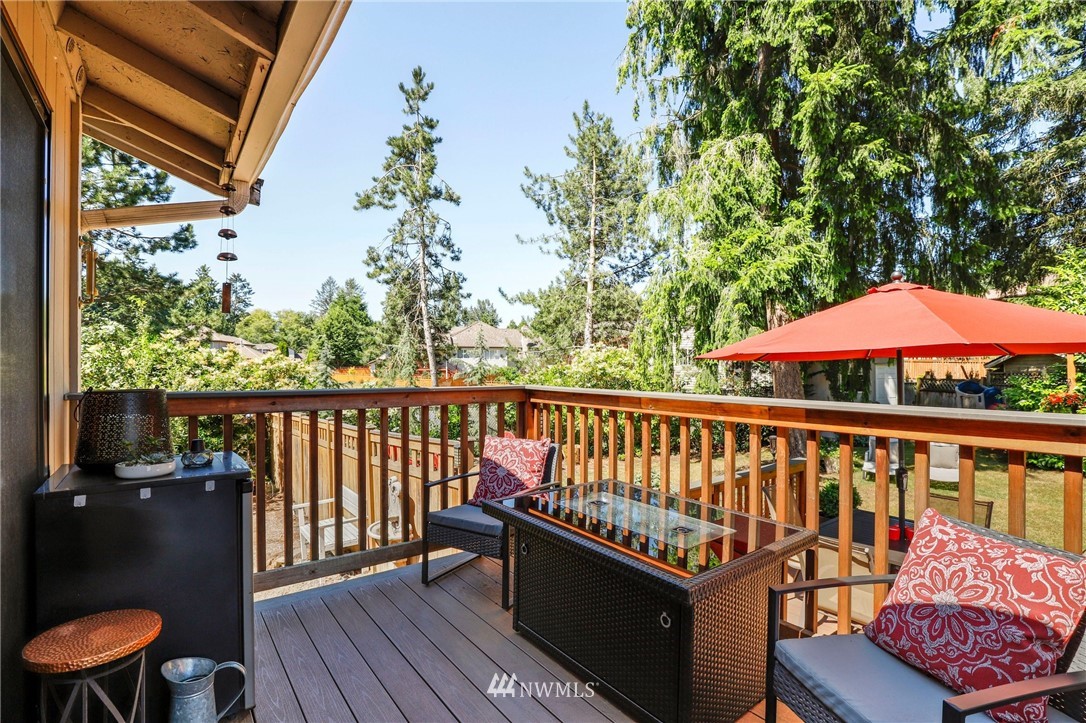 1417 234th Street Southwest Bothell, WA 98021 - Photo 24 of 40 a balcony with wooden floor table and chairs