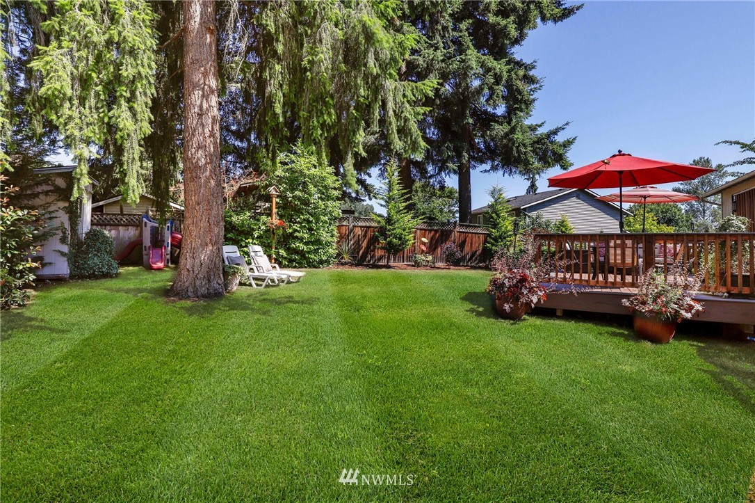 1417 234th Street Southwest Bothell, WA 98021 - Photo 29 of 40 a view of a backyard with a garden and trees