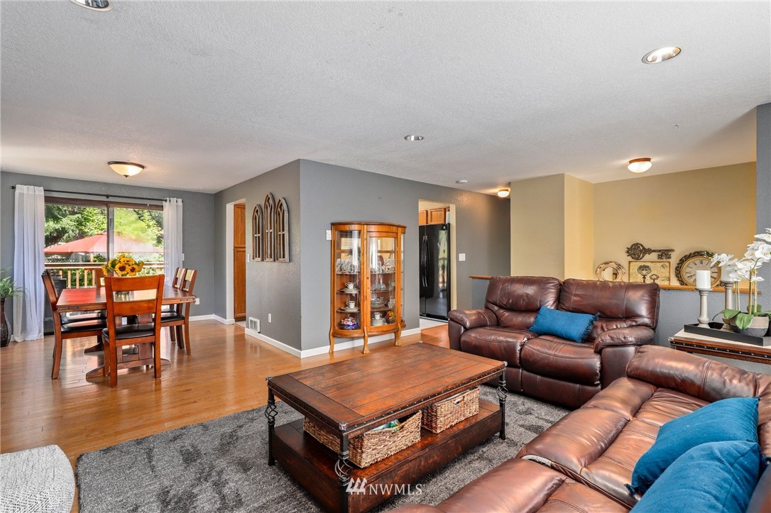 1417 234th Street Southwest Bothell, WA 98021 - Photo 4 of 40 a living room with furniture a table and wooden floor