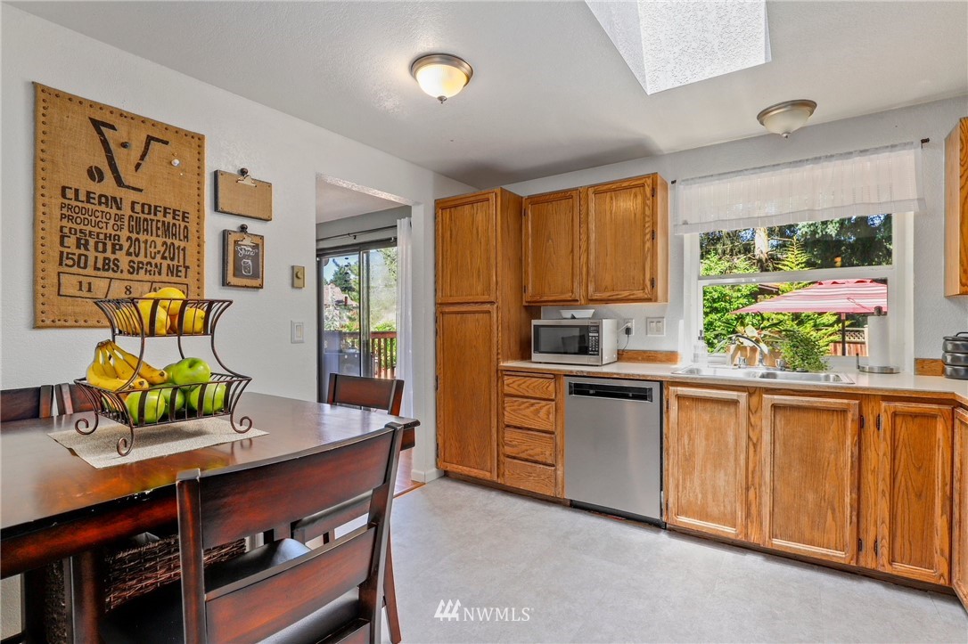 1417 234th Street Southwest Bothell, WA 98021 - Photo 6 of 40 a kitchen with stainless steel appliances granite countertop a stove a sink and a microwave