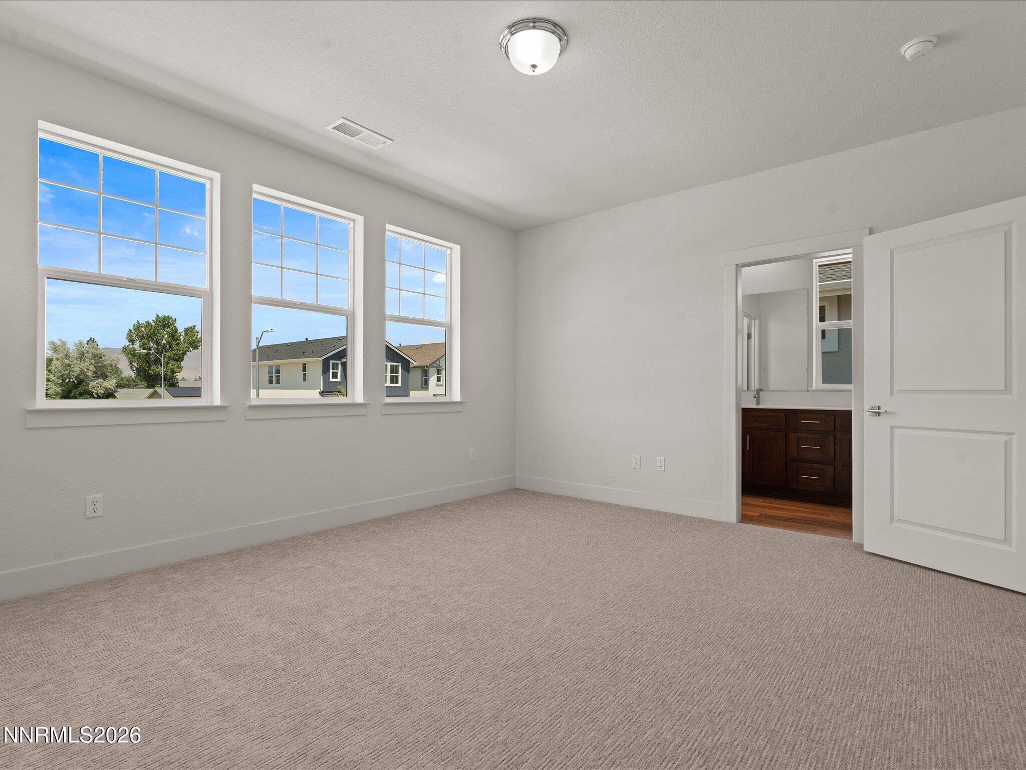 1371 Vine Gate Road, Unit HOMESITE 49 Carson City, NV 89701 - Photo 10 of 24 a view of an empty room with a window