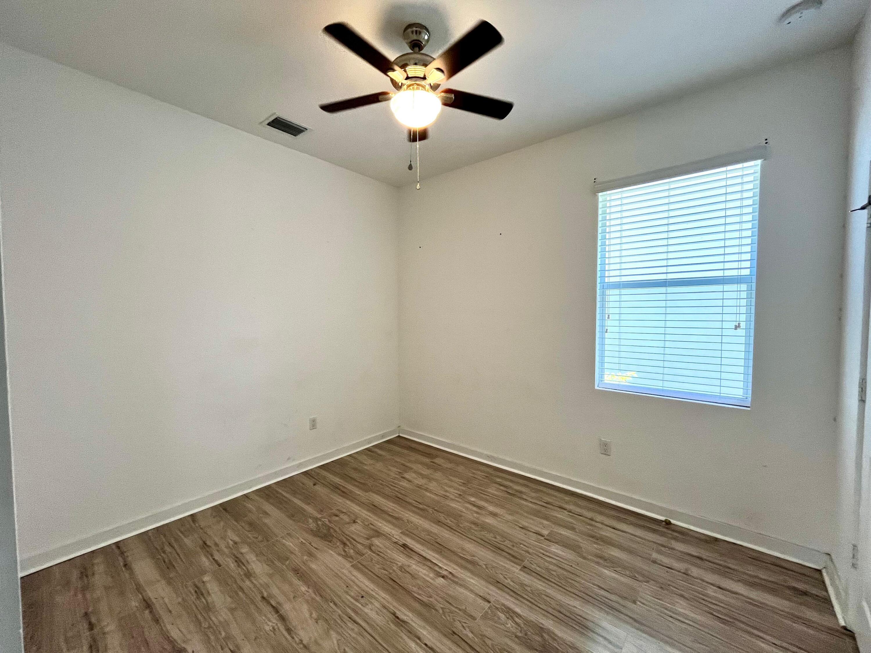6089 Wildfire Way West Palm Beach, FL 33415 - Photo 16 of 21 an empty room with a window and a fan
