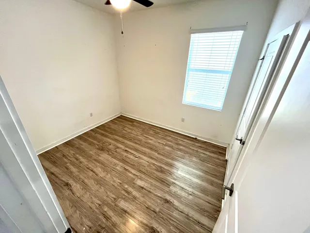 a view of wooden floor and windows in a room