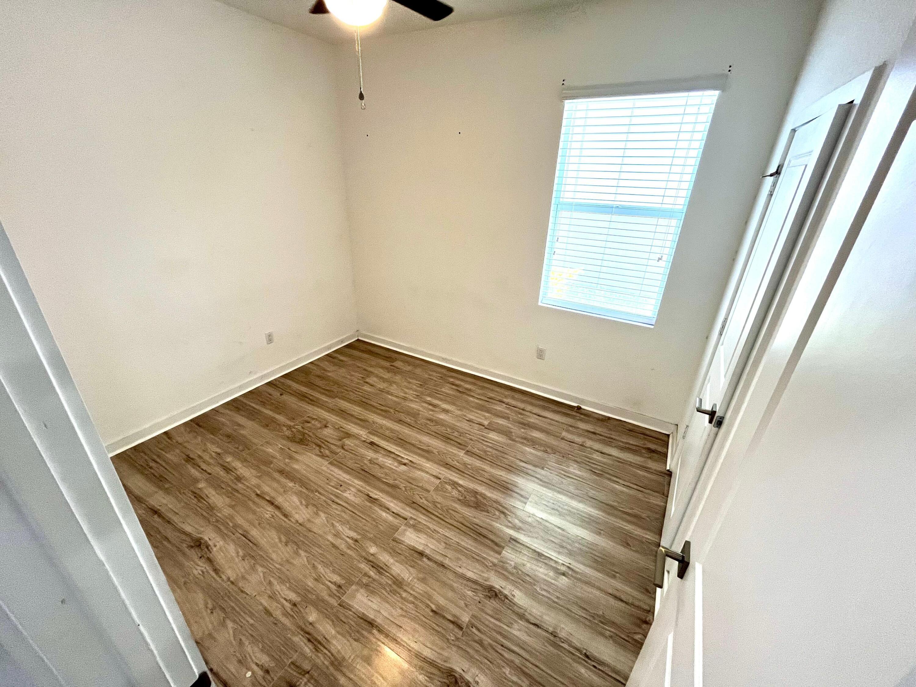 6089 Wildfire Way West Palm Beach, FL 33415 - Photo 17 of 21 a view of wooden floor and windows in a room