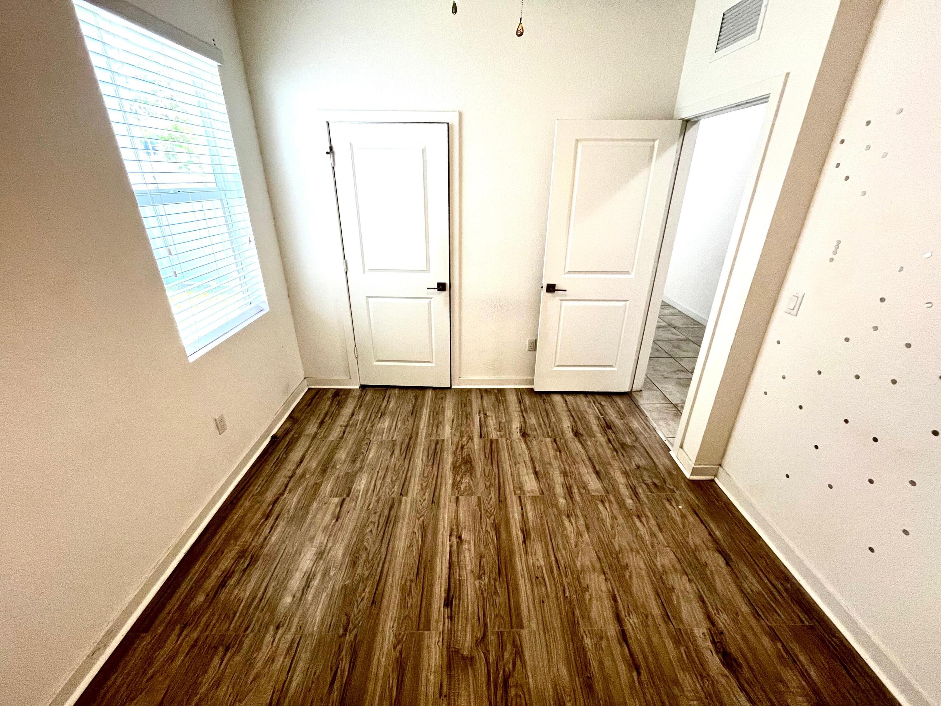 6089 Wildfire Way West Palm Beach, FL 33415 - Photo 18 of 21 a view of a room with wooden floor and windows