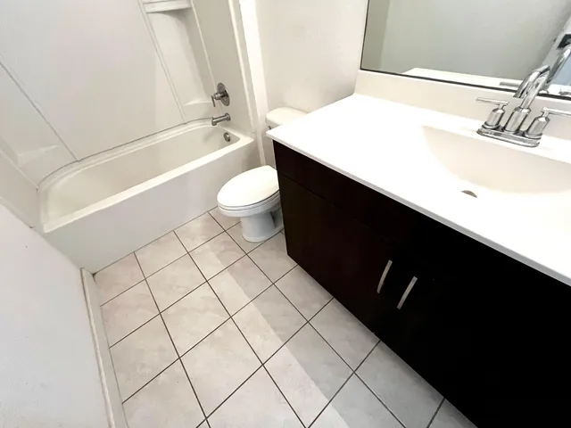 a bathroom with a sink a toilet and bathtub