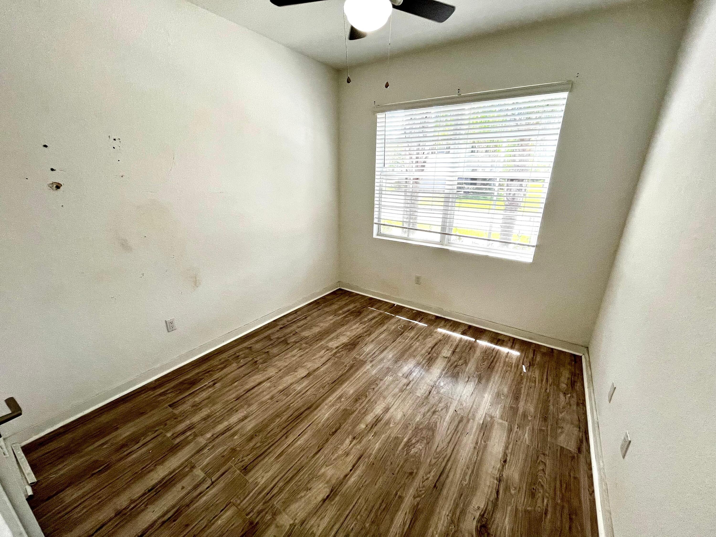 6089 Wildfire Way West Palm Beach, FL 33415 - Photo 21 of 21 a view of a room with wooden floor and windows