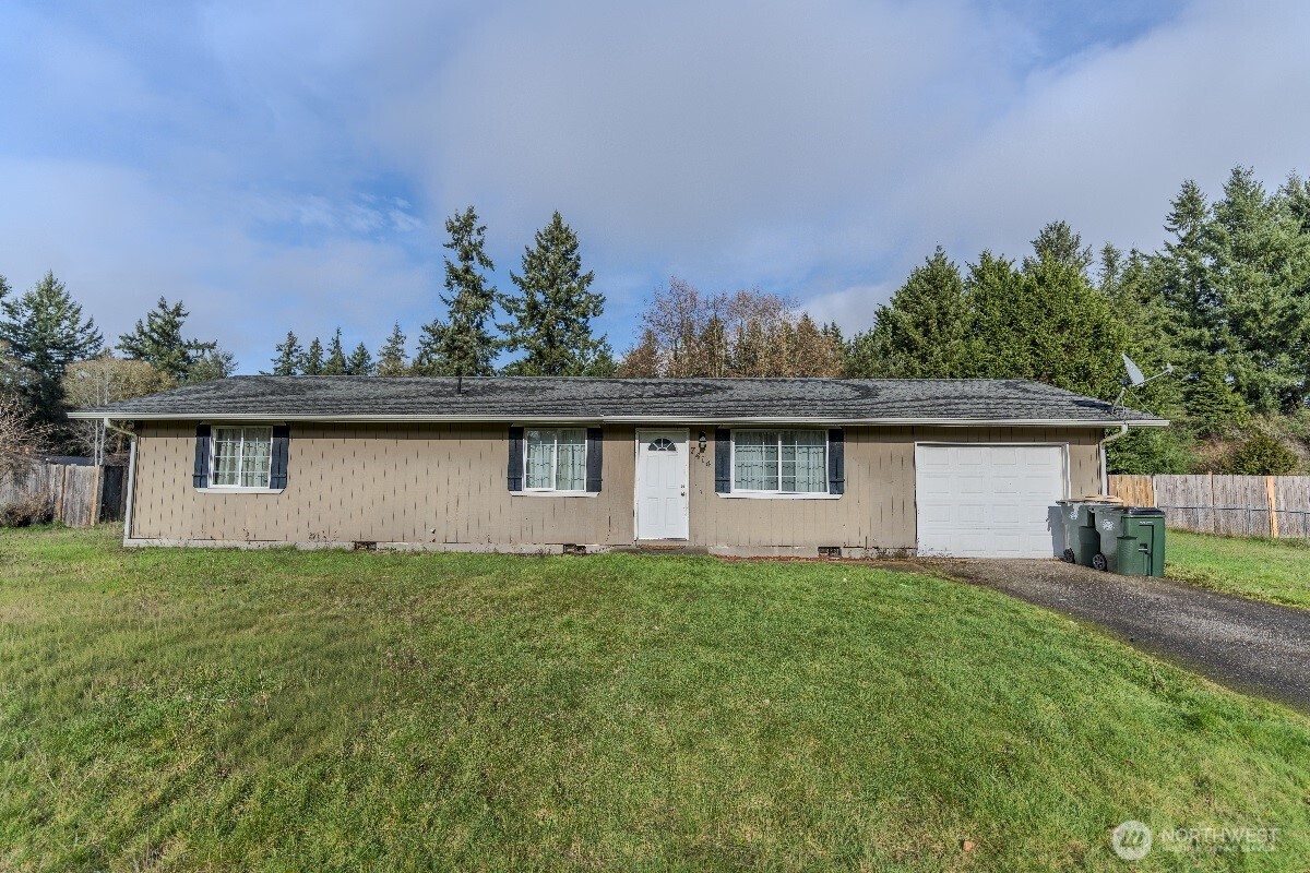 a view of a house with a yard and plants