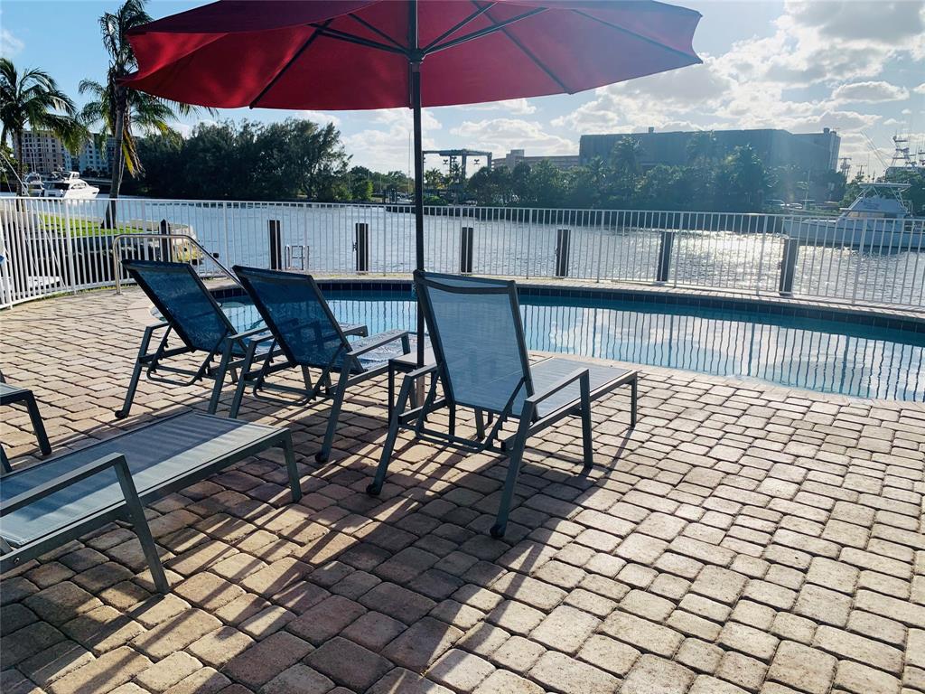 1705 North Riverside Drive, Unit 2 Pompano Beach, FL 33062 - Photo 15 of 60 a view of a roof deck with table and chairs under an umbrella