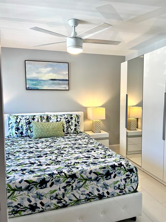 1705 North Riverside Drive, Unit 2 Pompano Beach, FL 33062 - Photo 19 of 60 a bedroom with a bed and a painting on the wall