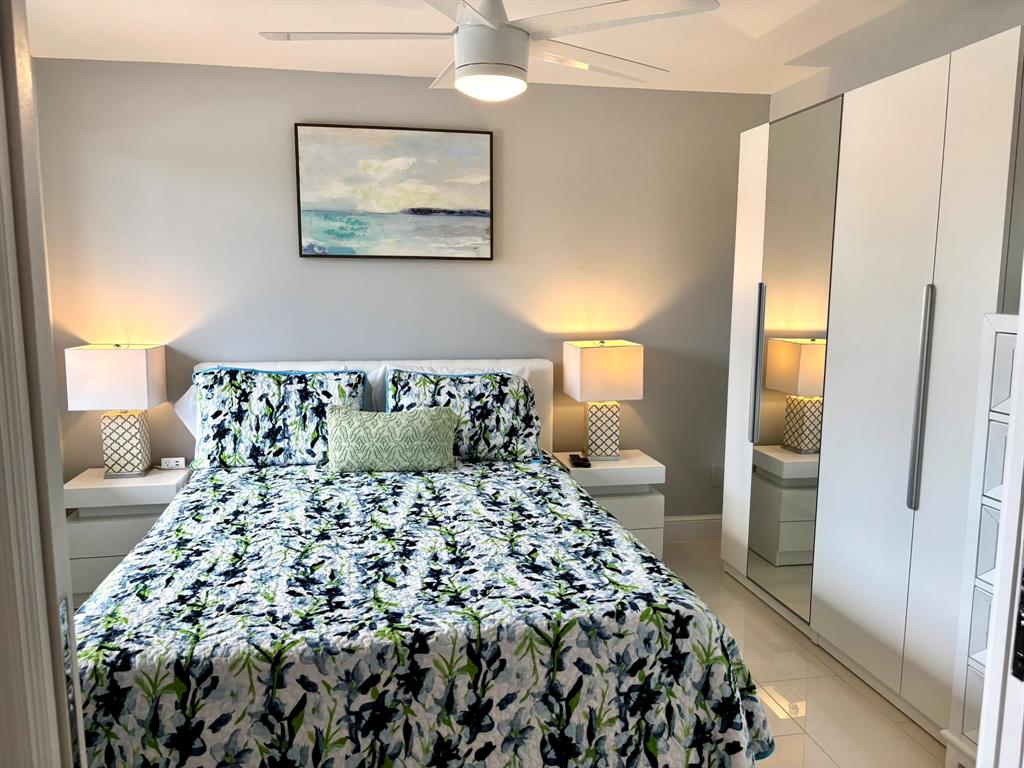 1705 North Riverside Drive, Unit 2 Pompano Beach, FL 33062 - Photo 21 of 60 a large bed sitting in a bedroom next to a bathroom